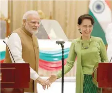  ?? — Reuters ?? Prime Minister Narendra Modi and Myanmar’s State Counselor Aung San Suu Kyi talk to reporters during their joint press conference in the Presidenti­al Palace in Naypyitaw on Wednesday.