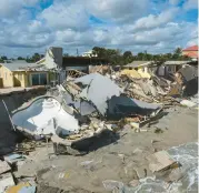  ?? AP ?? With Hurricane Nicole gone, the wreckage of homes litters the beach Friday in Wilbur-by-the-Sea, Fla.