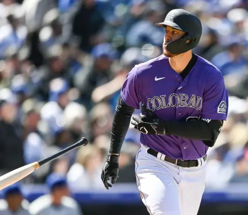  ?? Dustin Bradford, Getty Images ?? Colorado’s C.J. Cron tosses his bat after hitting a third inning two-run home run against the Los Angeles Dodgers at Coors Field on Sunday.