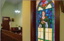  ??  ?? A view of the choir alcove and a stained glass window with an image of Susannna Wesley, mother of John Wesley, founder of Methodism