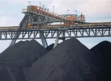  ?? /Reuters ?? Heaps of carbon: Coal is unloaded at the Ulan Coal mines near the New South Wales town of Mudgee in Australia. The country is the world’s largest coal exporter.