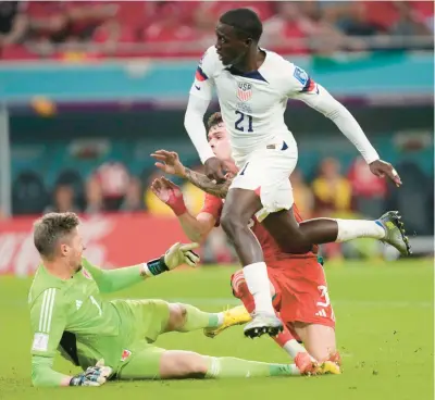  ?? DARKO VOJINOVIC/AP ?? Tim Weah scores in the first half but the U.S. settled for a draw in its World Cup group-play opener vs. Wales on Monday.