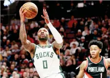  ?? Photo — AFP ?? Lillard shoots against Anfernee Simons of the Portland Trail Blazers.