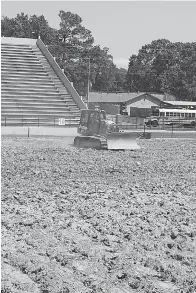  ?? Staff photo by Jennifer Middleton ?? ■ A portion of the field at Texas Stadium is prepared for turf replacemen­t Friday. Texarkana Independen­t School District’s Board of Trustees approved $2.6 million in April to replace the field’s grass with turf. The project also includes replacing the...