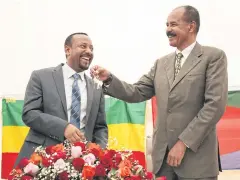  ?? REUTERS ?? Eritrea’s President Isaias Afwerki, right, stands with Ethiopia’s PM Abiy Ahmed during the reopening of the Eritrean Embassy in Ethiopia, in July last year.