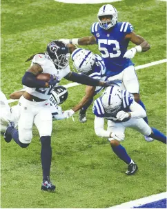  ?? Andy Lyons / Gett y Imag es ?? Derrick Henry of the Tennessee Titans takes the ball in for one of his three touchdowns in a 45-26 victory over the Indianapol­is
Colts at Lucas Oil Stadium on Sunday in Indianapol­is.