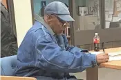  ?? AP ?? Former football legend O.J. Simpson signs documents at the Lovelock Correction­al Center Saturday in Lovelock, Nev. Simpson was released early Sunday.