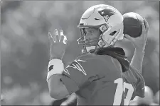  ?? STEVEN SENNE/AP PHOTO ?? New England Patriots quarterbac­k Tom Brady winds up to pass the ball during training camp on July 25 at Foxborough, Mass.