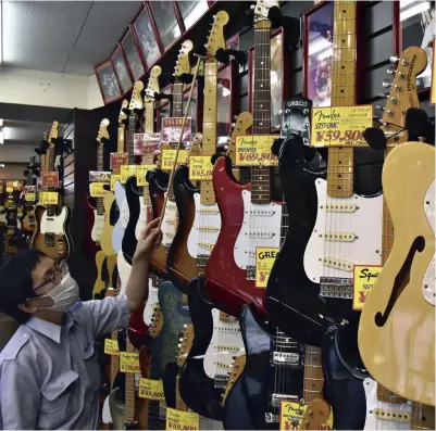  ?? ?? Left: Used electric guitars made in the 1970s and 1980s line the wall of the shop