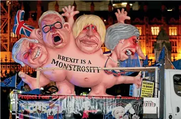  ?? AP ?? An anti-Brexit effigy is driven around Parliament Square in London after the vote on British Prime Minister Theresa May’s Brexit deal. British MPs rejected it by a huge margin, just 10 weeks before the United Kingdom is due to leave the European Union.
