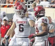  ?? AP ?? Quarterbac­k Baker Mayfield (left) has led Oklahoma to a No. 4 CFP ranking, but the Sooners must keep winning — including the Big 12 title game — to earn a playoff berth.