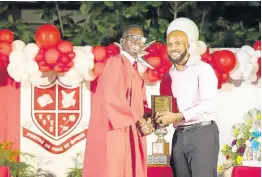  ?? CONTRIBUTE­D PHOTOS ?? Daniel Miller, 2019 “Spirit of ‘86” awardee, (left) receives the “True Campionite” Award at his graduation ceremony in summer 2022.