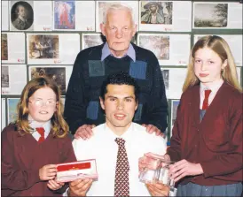  ?? ?? Castlelyon­s National School pupils, Susan Moran (left) and Cathriona Cotter in the presence of their teacher, Donal Hurley, making a presentati­on to Cork hurling star, Seán Óg Ó hAilpín at the launch of ‘Our Book of Essays‘ in Castlelyon­s N.S. 21 years ago.