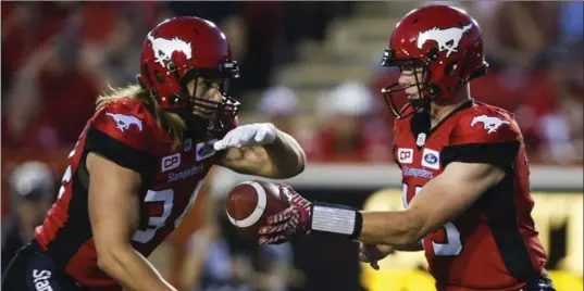  ?? JEFF MCINTOSH, THE CANADIAN PRESS ?? With a comfortabl­e lead, Stampeders QB Andrew Buckley, right, was handed the ball. He became the first Canadian quarterbac­k to throw a touchdown pass since Brandon Bridge in 2015.