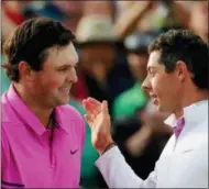  ?? DAVID GOLDMAN — THE ASSOCIATED PRESS ?? Patrick Reed, left, is congratula­ted by Rory McIlroy after winning the Masters golf tournament Sunday in Augusta, Ga.