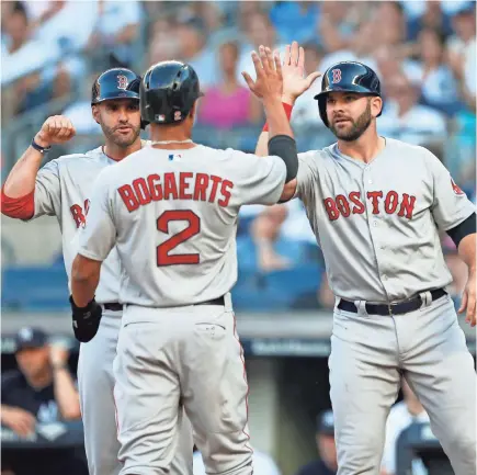  ??  ?? The Red Sox, including Xander Bogaerts, J.D. Martinez and Mitch Moreland, lead the AL East.