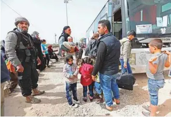  ?? AFP ?? ■ Residents who were evacuated from the rebel-held town of Harasta in Eastern Ghouta arrive at a camp for displaced people in Maaret Al Ikhwan, in rebel-held Idlib province, yesterday.