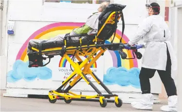  ?? RYAN REMIORZ / THE CANADIAN PRESS ?? A patient is brought to the emergency department at a hospital in St. Eustache, Que., on Wednesday.