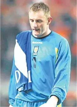  ?? Picture: SNS. ?? Rab Douglas walks off the pitch in Amsterdam after Scotland lost 6-0 in their Euro 2004 play-off clash.