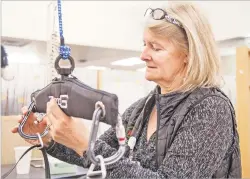  ?? GABRIELA CAMPOS/THE NEW MEXICAN ?? Physical therapist Marlies Hokbergen adjusts the ZeroG at at Christus St. Vincent Regional Medical Center.