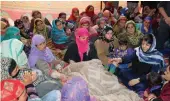  ?? — PTI ?? J&K chief minister Mehbooba Mufti visits the family of J&K Bank employee who was killed by the suspected militants during in Kulgam district of south Kashmir on Wednesday.