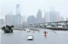  ??  ?? Parts of Interstate 45 were submerged, left, while a photograph of the La Vita Bella care home, right, went viral after those trapped inside were forced to tweet for help