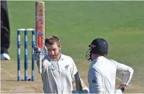  ?? – AFP ?? MATCH WINNER: New Zealand’s captain Kane Williamson, left, celebrates his century with teammate Henry Nicholls during the fifth day of their first Test gainst Bangladesh at Wellington.