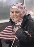 ?? SCOTT OLSON, GETTY IMAGES ?? Syrian refugee Baraa Haj Khalaf clutches an American flag after arriving with her family in Chicago on Feb. 7.