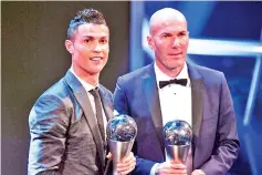  ?? — AFP photo ?? Real Madrid’s French coach Zinedine Zidane (R) stands with his trophy for winningThe Best FIFA Men’s Coach of 2017 Award alongside Real Madrid and Portugal forward Cristiano Ronaldo, with his trophy for winning The Best FIFA Men’s Player of 2017 Award...