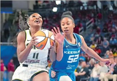  ?? CHARLES REX ARBOGAST/AP PHOTO ?? Dana Evans of the Chicago Sky (11) drives to the basket past the Connecticu­t Sun’s Ty Harris during a WNBA game on July 12.