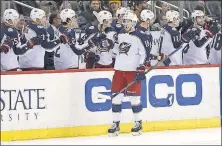  ?? [KEITH SRAKOCIC/THE ASSOCIATED PRESS] ?? Pierre-Luc Dubois is greeted by his Blue Jackets teammates after scoring against the Penguins on Thursday.