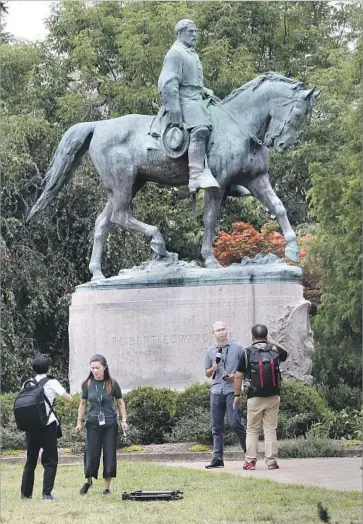  ?? Steve Helber Associated Press ?? THE PLANNED REMOVAL of the statue of Gen. Robert E. Lee in Charlottes­ville, Va., led to violent protest.
