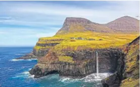  ??  ?? The Mulafossur waterfall by a typical Faroese village