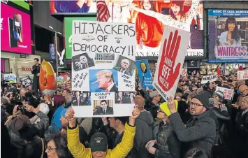  ?? ALVAREZ Picture: GETTY IMAGES/AFPE/DUARDO MUNOZ ?? UNITED FRONT: People attend a protest, after President Donald Trump fIred attorney-general Jeff Sessions, in Times Square in New York City. Trump replaced him with Mathew Whitaker, accused of opposing a probe into Trump’s possible collusion with Russia.