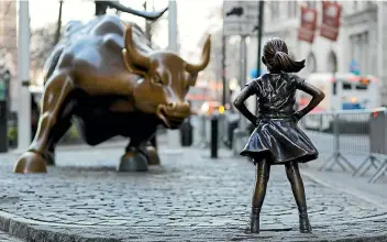  ?? ?? The Fearless Girl statue is a symbol of women participat­ing in a world of money and finance. A lot has changed for women in the economy, but economic parity has not been achieved.