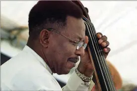  ?? FILE ?? Eddie Brookshire plays the upright bass with his Dayton-based band, Eddie Brookshire’s Big Band, at the Women In Jazz Festival in downtown Dayton in 2003.