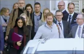  ?? AUSTRALIAN POOL VIA AP ?? In this image made from video, Britain’s Prince Harry, center right, and his wife Meghan Markle, left, Duke and Duchess of Sussex, approach a car at an airport in Sydney.