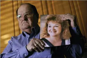 ?? AP PHOTO/CHARLIE RIEDEL ?? Mortuary owner Brian Simmons holds a photo of his daughter Rhonda Ketchum who died before Christmas of COVID-19, Thursday, Jan. 28, in Springfiel­d, Mo.