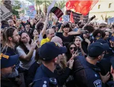  ?? — AFP photo ?? Israeli police disperse a protest calling for a ceasefire and for the release of Israeli hostages held in Gaza in the northern port city of Haifa.