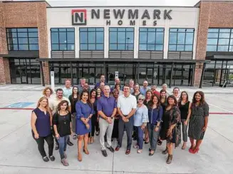  ?? Steve Gonzales / Staff photograph­er ?? Members of Newmark Homes Houston take timeout for a photo in front of their new Katy building near the Grand Parkway.