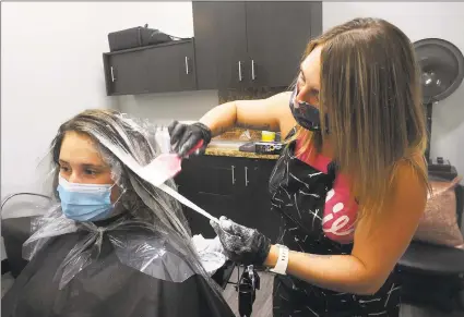  ?? Ned Gerard / Hearst Connecticu­t Media ?? Jamie Rotunno works on the hair of client Lauren O’Brien, of Ansonia, in the Dye Hard Hair suite located in the My Salon Suite franchise location in Shelton on Wednesday.