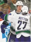  ?? Jim Mone / Associated Press ?? Vancouver’s Brock Boeser is greeted by Ben Hutton after scoring a goal in his NHL debut in St. Paul, Minn.