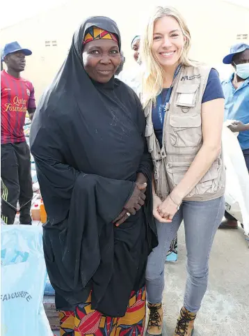  ??  ?? Internatio­nal Medical Corps Global Ambassador, Sienna Miller (right) meets a woman displaced by the Boko Haram insurgency in northeast Nigeria’s hard-hit Borno State.