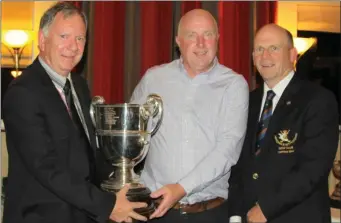  ??  ?? Derek Murray, winner of the Delany Cup at Laytown & Bettystown Golf Club, is presented with his trophy by Mr Tom Delany, representi­ng the Delany family, and Captain Denis Taylor.