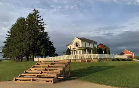  ??  ?? The original bleachers and farmhouse used in the 1989 movie “Field of Dreams.” Much of the movie was filmed at the farm in Dyersville, Iowa. Fans still visit the iconic location.