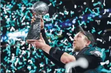  ?? KEVIN LAMARQUE / REUTERS ?? Eagles quarterbac­k and Super Bowl MVP Nick Foles hoists the Vince Lombardi Trophy after vanquishin­g the heavily-favored Patriots.