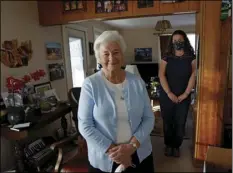  ?? AP PHOTO/JEFF SWINGER ?? Marjan Martin Curtis (left) and Amy Baird pose at Curtis’ home on Thursday in Spanish Fork, Utah.