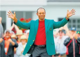  ?? /Kevin C Cox/Getty Images ?? If the jacket fits: Tiger Woods celebrates his Masters victory on April 14 2019. He says it feels odd keeping the green jacket for another seven months.