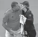  ?? GETTY IMAGES ?? Lee Westwood kisses his caddie and girlfriend Helen Storey on the 18th green after his 65 on Saturday.