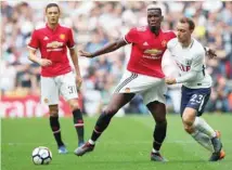  ??  ?? Manchester United’s Paul Pogba in action with Tottenham’s Christian Eriksen. — Reuters